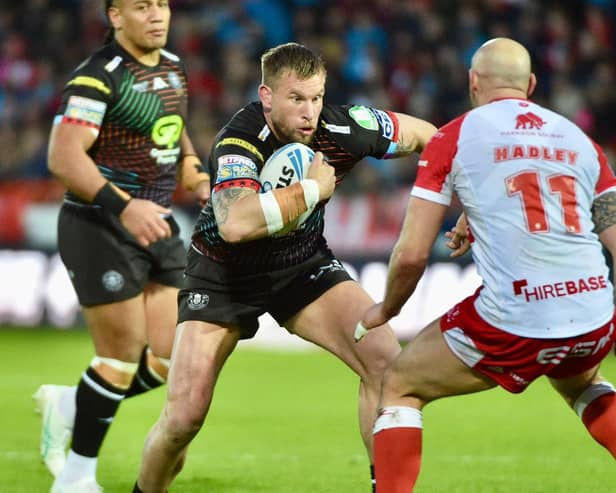 Mike Cooper has returned to Wigan's 21-man squad for the trip to Huddersfield
