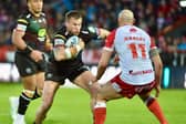 Mike Cooper has returned to Wigan's 21-man squad for the trip to Huddersfield