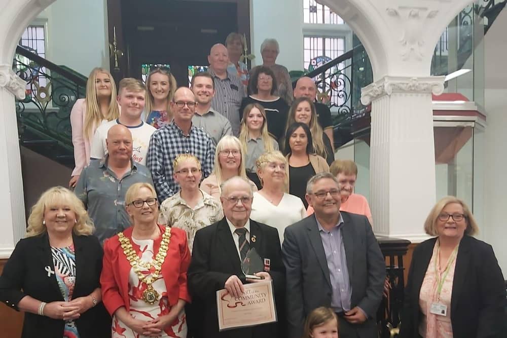 Friends and family of Derek Green surprised him at Wigan Town Hall as he was presented with the Heart of the Community Award