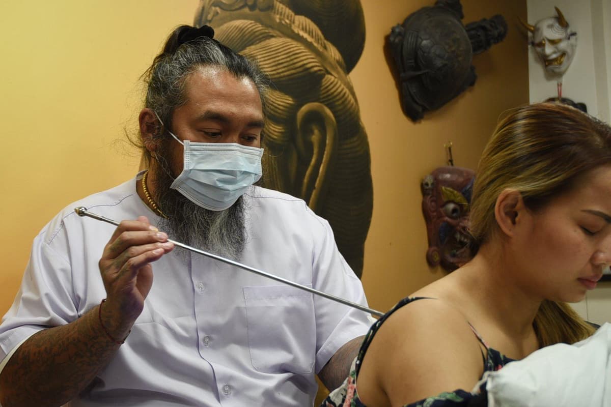 Famous Thai master of tattoo art visits Wigan to practise ancient