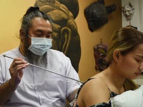 Skin Graffiti Tattoo Studio, Wigan, hosts Ajarn Ohr, a Sak Yant Master from Thailand, using traditional methods to create tattoos and blesses them.