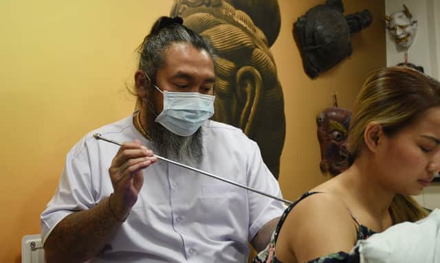 Skin Graffiti Tattoo Studio, Wigan, hosts Ajarn Ohr, a Sak Yant Master from Thailand, using traditional methods to create tattoos and blesses them.