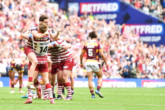 The Wigan players celebrate on the full time whistle.
