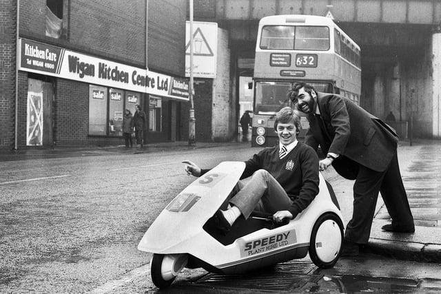 Wigan Rugby League Club star full-back Steve Hampson tests the newly launched Sinclair C5 electric car at Speedy Plant Hire on Wallgate on Tuesday 29th of January 1985.