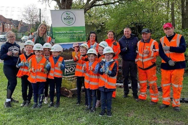 Lowton St Luke's Primary School pupils taking part in the planting activity with some of the Murphy team