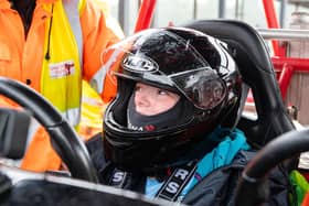 A youngster is fitted for her ride in a kart at Three Sisters circuit for the Speed of Sight fun day