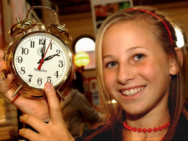 Courtney Hesketh from Standish with a clock from Paul Brandon's jewellers stall in Wigan market hall reminds us of British Summer Time's end in 2006