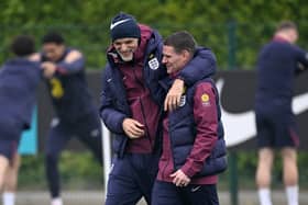 Thomas Tuchel and Anthony Barry share a joke during England training