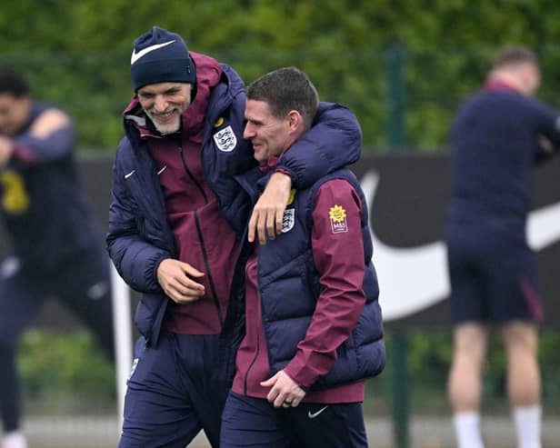 Thomas Tuchel and Anthony Barry share a joke during England training