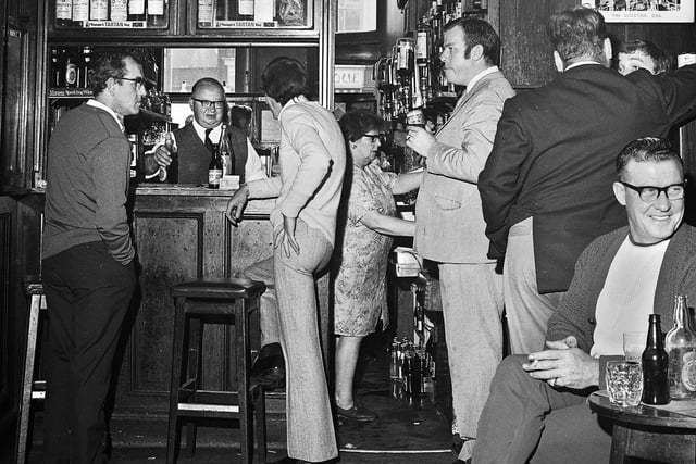 Landlord Colin Cook behind the bar in the Market Hotel, Wigan, in October 1971.