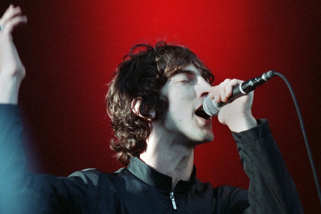 Richard Ashcroft in good voice at Haigh Hall.   The Verve’s homecoming gig at Haigh Hall on Sunday 24th May 1998.  The event attracted over 32,000 fans to the country park and before the show started some fans knocked down a perimeter fence. The Verve played their historic set and singer Richard Ashcroft reminded the audience that the band had come a long way since their early days playing to a few punters at The Honeysuckle pub in Poolstock. They were in good form and launched into their set including “Sonnet”, “The Drugs Don’t Work”, “Lucky Man” and “Bitter Sweet Symphony”.  The fans loved it and Richard Ashcroft described it as one of the greatest days of his life (words by photographer Frank Orrell).