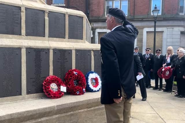 A veteran salutes the cenotaph after laying a wreath