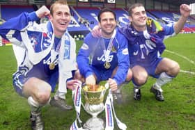 Celebrations from Neil Roberts, Andy Liddell and Lee McCulloch as Wigan Athletic lift the Division 2 championship trophy after beating Barnsley 1-0 with a Tony Dinning goal  on Saturday 3rd of May, the last day of the 2002/2003 season.
