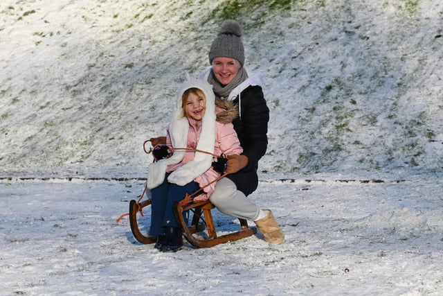 Wigan snow scenes - People make the most of the winter weather as snow falls on Mesnes Park, Wigan.