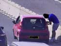 The motorist adjusting his wing mirror