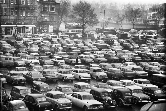 Wigan market square with some classic cars on view in the 1960s.