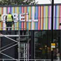 A workman puts the finishing touches to Wigan's new Taco Bell