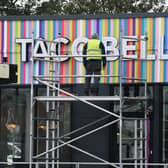 A workman puts the finishing touches to Wigan's new Taco Bell