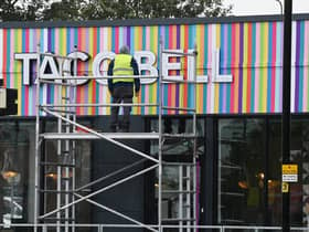 A workman puts the finishing touches to Wigan's new Taco Bell