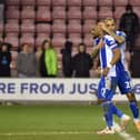 Josh Magennis consoles Tendayi Darikwa after his penalty miss against Sutton