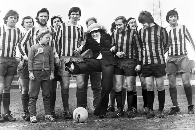 Actress Nerys Hughes who played Sandra in the television comedy "The Liver Birds" attempts the kick off for a Liverpool County FA fixture at Springfield Park on Saturday 5th of April 1975.