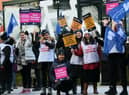 Nurses waved flags and carried placards on the picket line