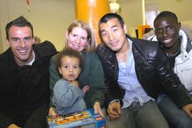 Wigan Athletic players deliver Christmas presents on Rainbow Ward at Wigan Infirmary. Patient Elliott with Joanne Brown and players Antonio  Amaya, Won Hee Cho and Momo Diame