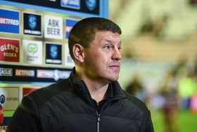 Wigan Warriors moved one step closer to retaining the League Leaders' Shield with a 38-0 win over Leeds Rhinos