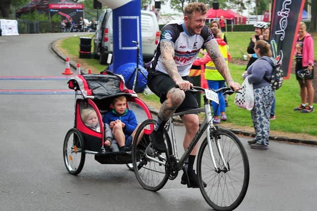 Jack Johnson with rugby player Josh Charnley during the Wigan Bike Ride