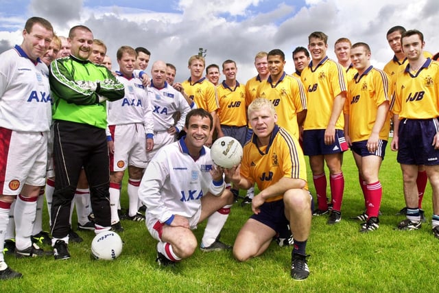 A different ball game for Wigan Rugby League Club star, Mick Cassidy, as he lines up with Coronation Street's, Kevin Webster, and the teams at the start of his all stars testimonial soccer match at Edge Hall Road on Monday 28th of August 2000.