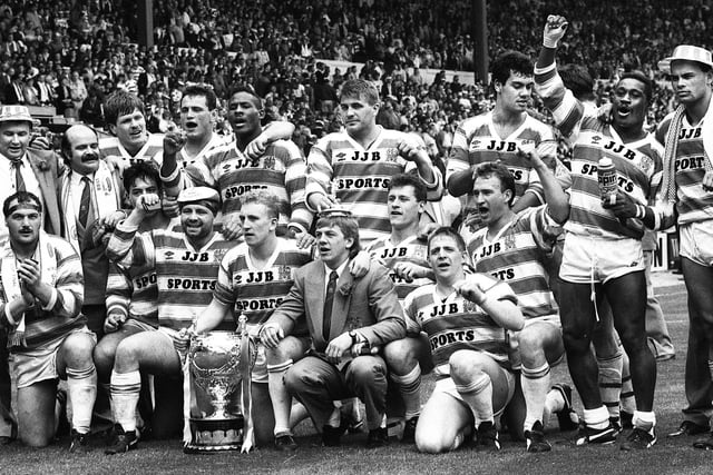 The Wigan team and injured Steve Hampson celebrate with the trophy after beating Halifax in the Challenge Cup Final at Wembley on Saturday 29th of April 1988. Wigan won the match 32-12.