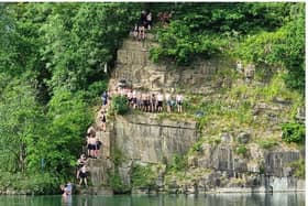 An old picture of teenagers jumping in the quarry in Appley Bridge