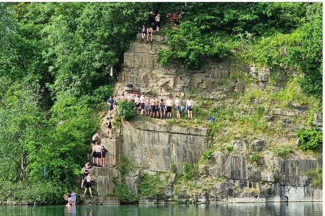 An old picture of teenagers jumping in the quarry in Appley Bridge