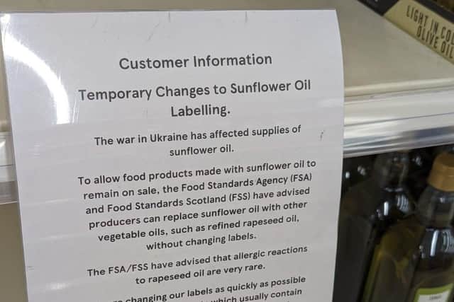 Signs are placed on shelves to inform customers of changes