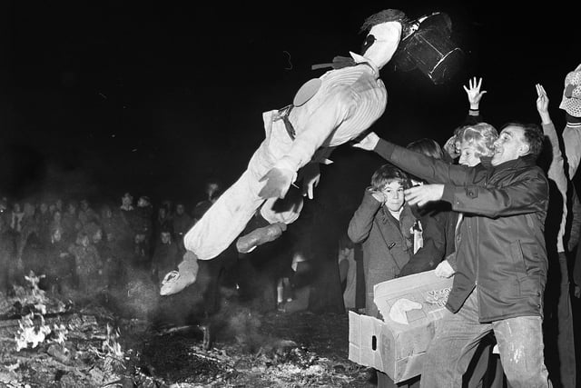 The guy is tossed on the fire on bonfire night at Comet Youth Club, Poolstock, on Friday 5th of November 1976.