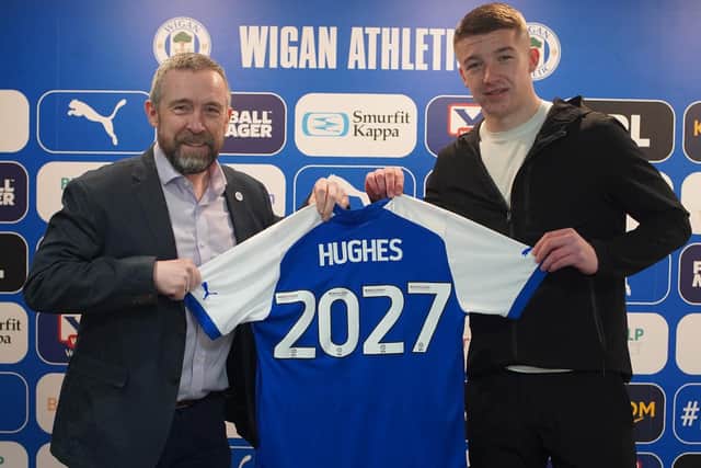 Charlie Hughes celebrates signing his new long-term contract with Latics CEO Mal Brannigan