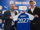 Charlie Hughes celebrates signing his new long-term contract with Latics CEO Mal Brannigan
