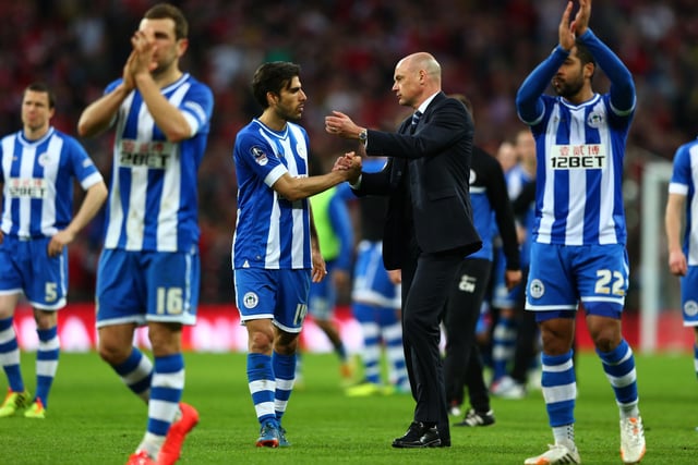 Uwe Rosler, manager of Wigan Athletic consoles Jordi Gomez of Wigan Athletic during the FA Cup Semi-Final match between Wigan Athletic and Arsenal at Wembley Stadium on April 12, 2014 in London, England.