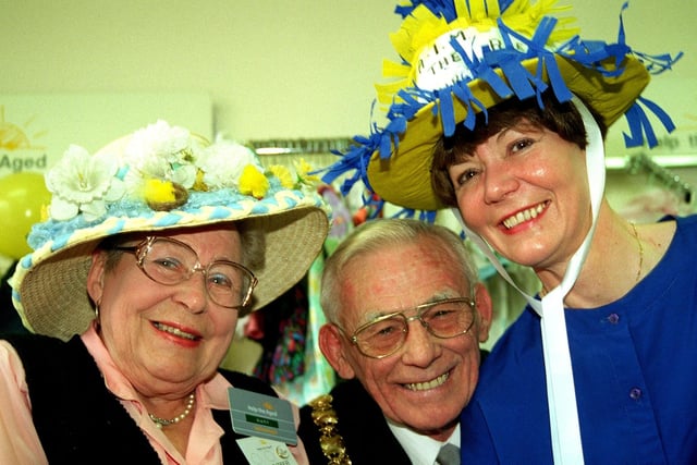 Former Wigan Mayor Coun Bernard Coyle  joined in the 10th  Birthday Party for the Help the Aged shop on Gerrard street, Ashton in Makerfield. he is pictured with  Marty Jones (left ) and Deputy Manageress  Diane Catterall wearing their Easter Bonnets,