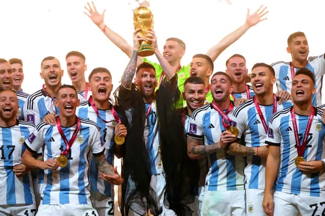 Argentina captain Lionel Messi lifts the World Cup trophy (PA)