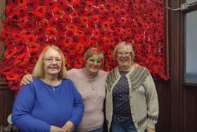 Some of the knitters show off their moving and impressive handiwork