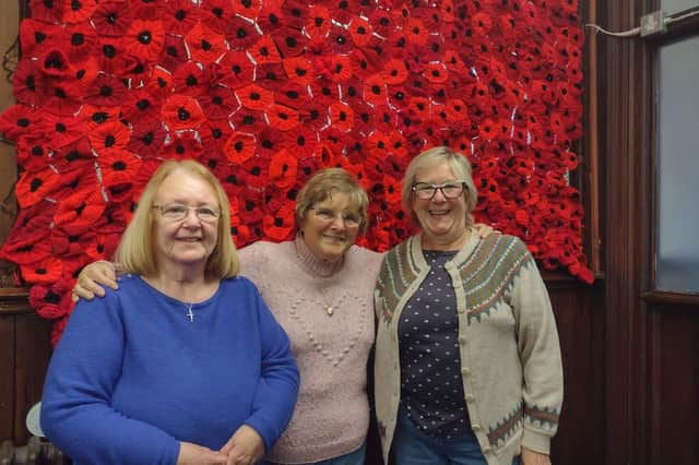 Some of the knitters show off their moving and impressive handiwork
