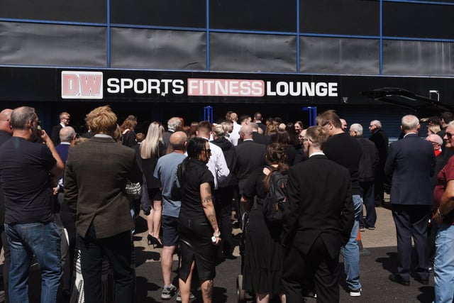 Hundreds of people gathered outside the DW Stadium ahead of the service.