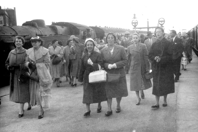 Coops employees arriving for a day out in Blackpool in August 1957