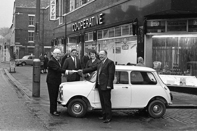RETRO 1969 - Manager of Wigan's CO-OP on Standishgate, at the corner of Powell Street, accepts the keys of a new Austin Mini won in a competition.