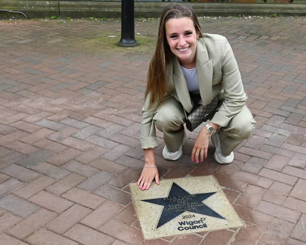Football champion Ella Toone, Lioness and European Championship Winner, with her star, placed outside Leigh Town Hall.