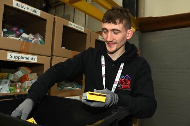 Sam Pitts sorting stock in the warehouse.