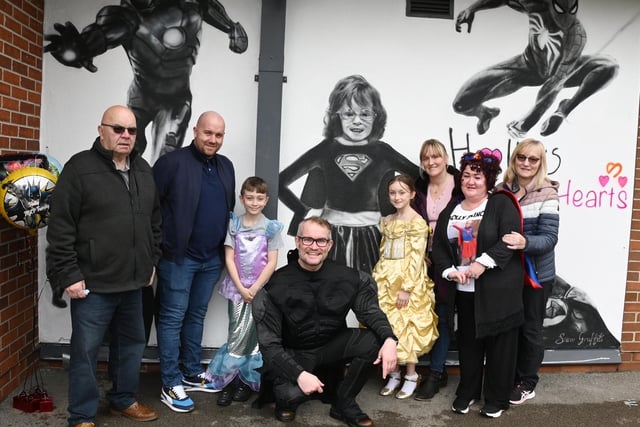 Headteacher Tim Mooney, centre, with Holly's family after the mural was unveiled