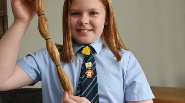 Poppy Touhey has cut off 12ins of her long hair to donate to the Little Princess Trust