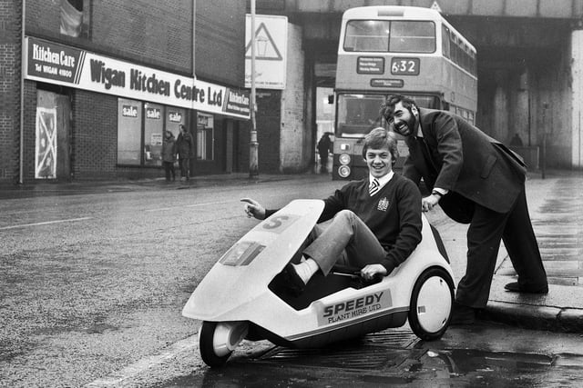 Wigan Rugby League Club star full-back Steve Hampson tests the newly launched Sinclair C5 electric car at Speedy Plant Hire on Wallgate on Tuesday 29th of January 1985.